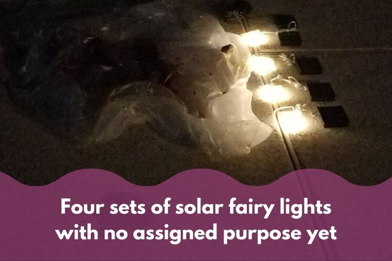 four sets of solar fairy lights laying on the ground