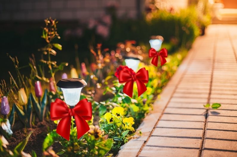 garden lights with fancy red bows