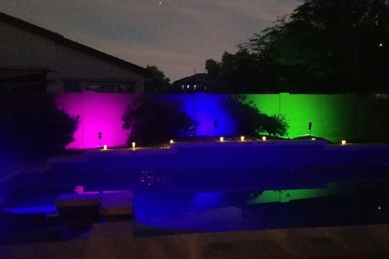 jsot rectangular solar spotlights in purple blue and green lighting up a concrete wall