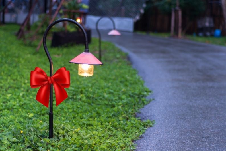 shepherds hook stake light with red bow accent