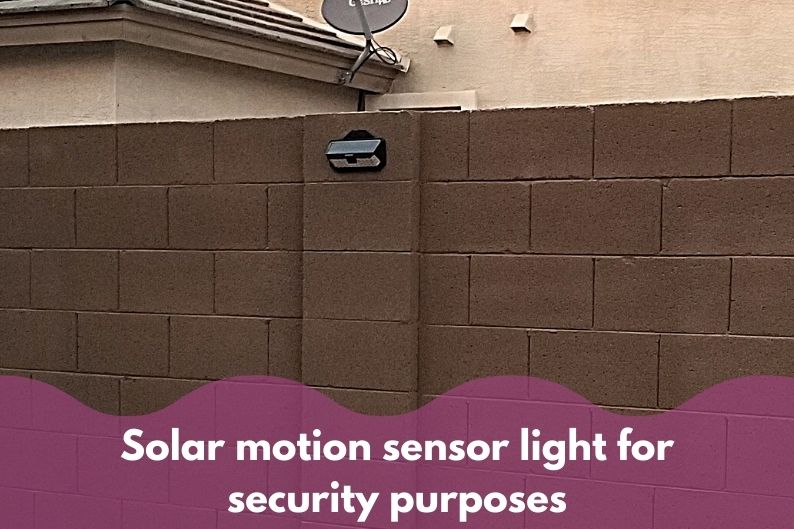 solar motion sensor light mounted on an outside wall