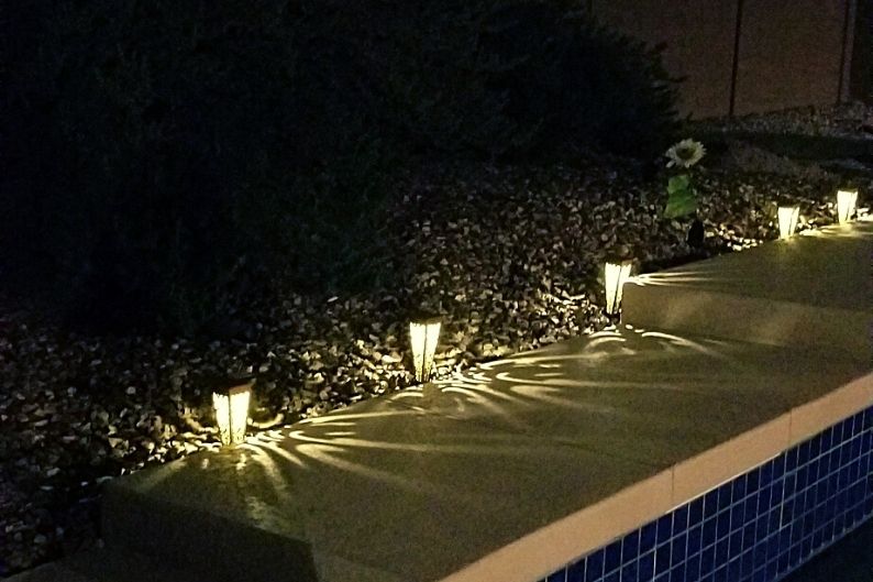 solar stake lights casting a pattern on a walkway