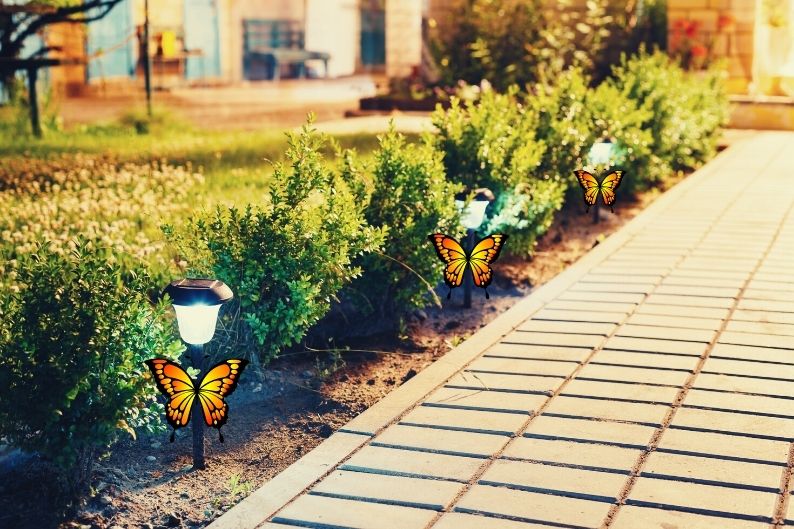 walkway stake lights with yellow butterflies attached