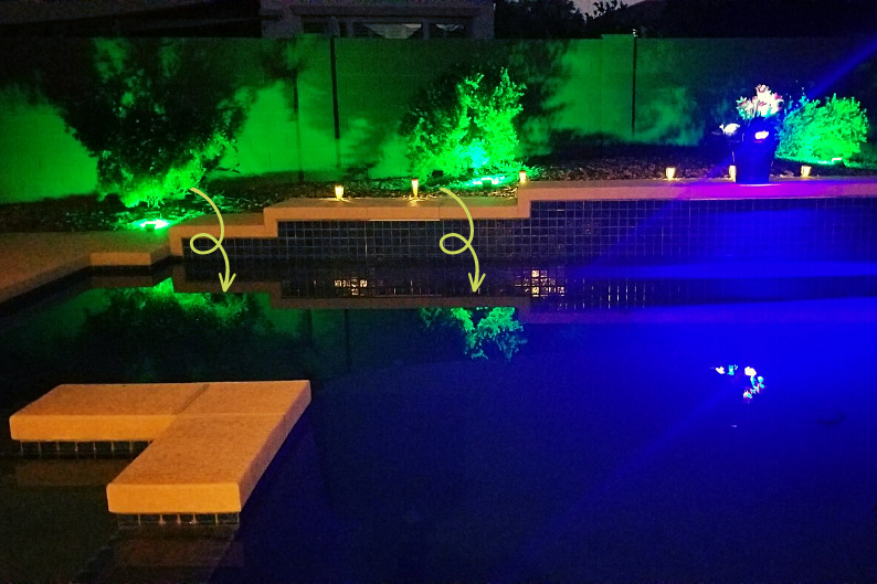 Reflection of green solar lights in pool surface