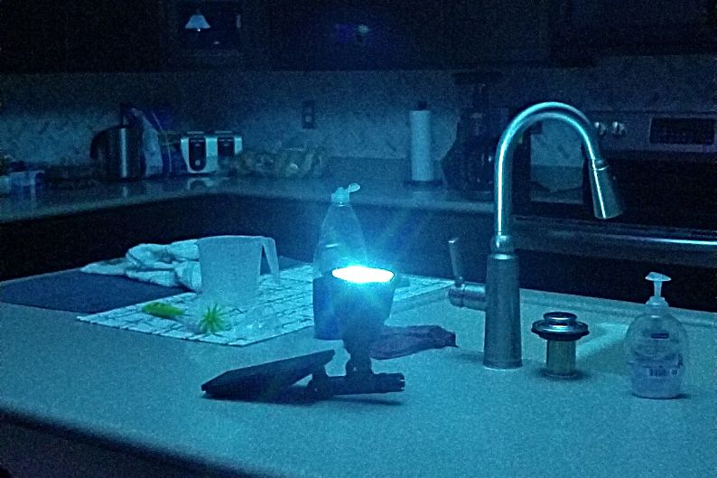 outdoor solar light pointing up in dark kitchen